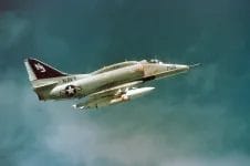 An air-to-air right side view of an Attack Squadron 127 (VA-127) A-4 Skyhawk aircraft.